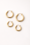 Voura gold hoop earrings set 3 pairs small medium large white studio background