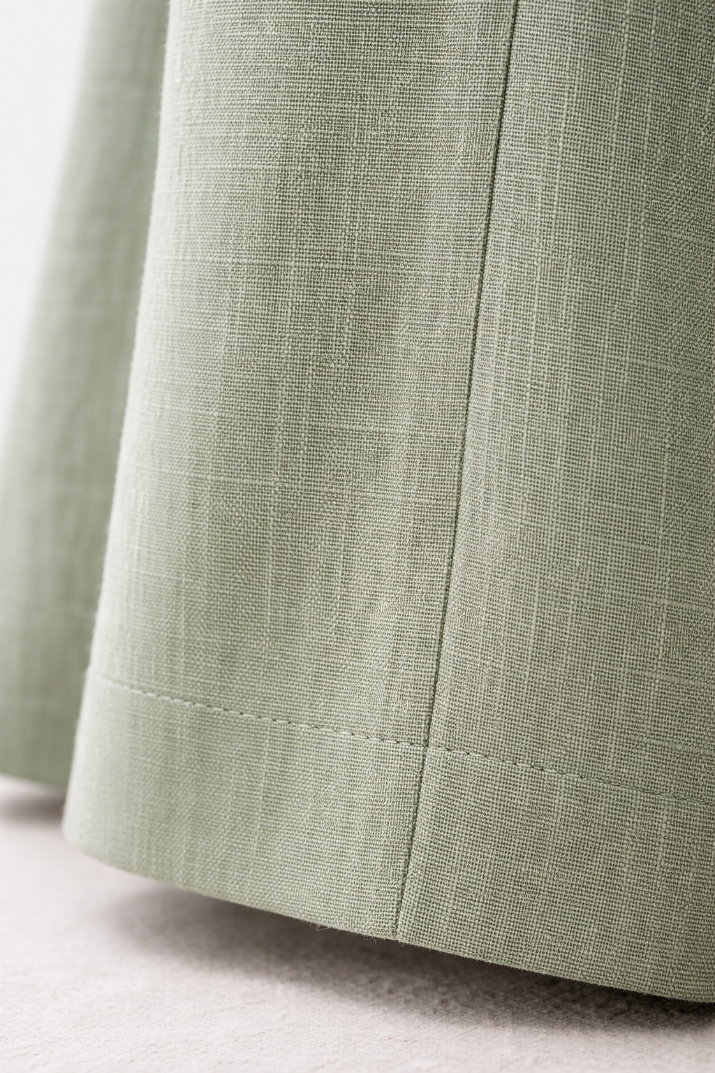 Close-up linen wide-leg trouser fabric texture and waistband detail