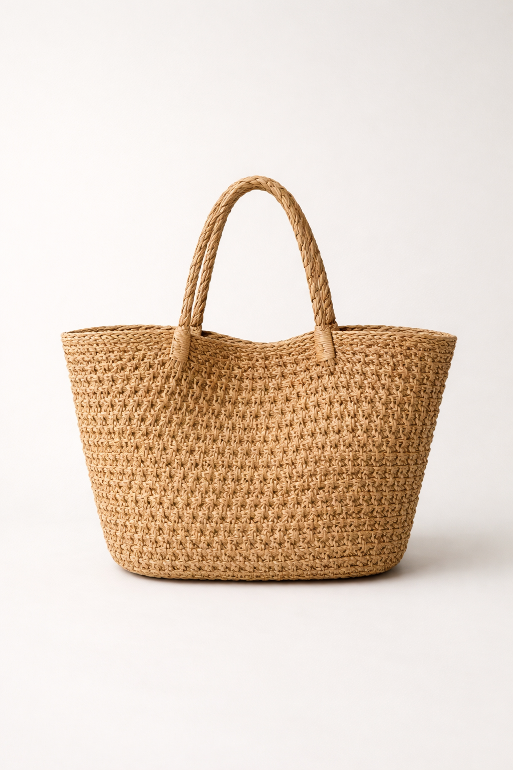 Voura natural woven raffia tote bag leather handles white studio background