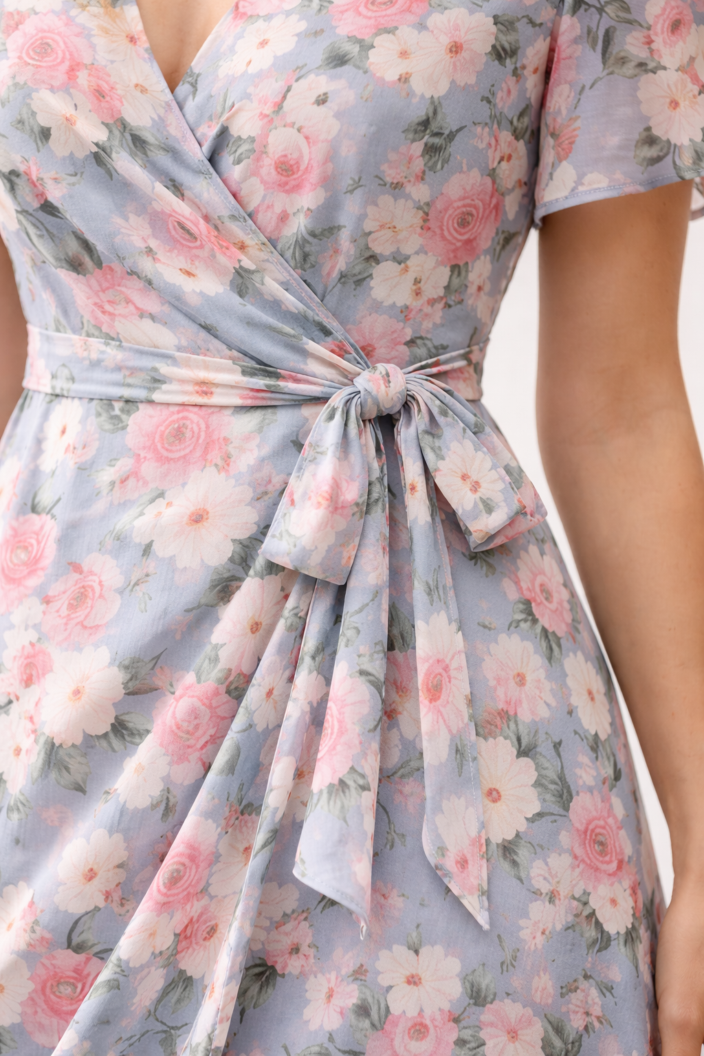 Close-up wrap midi dress tie detail and floral print fabric quality